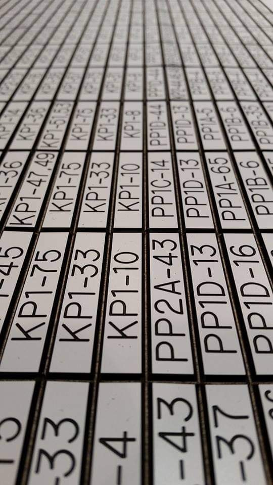 Close-up of a large engraved label sheet with KP1 and PP2 outlet identifiers