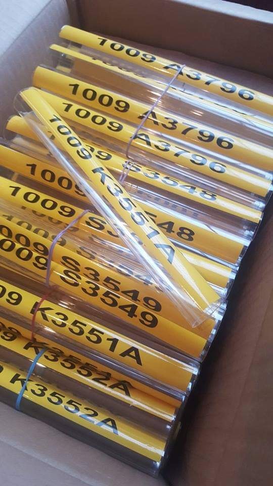 Large batch of engraved yellow conduit markers — 1009 A3796, S3548, K3551A series